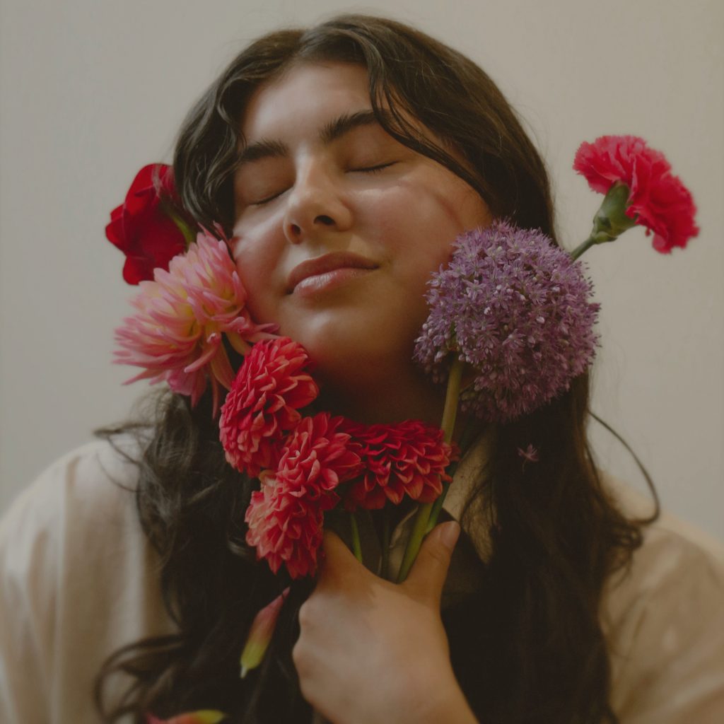 NYVE holding flowers for the cover of her single Be My Own