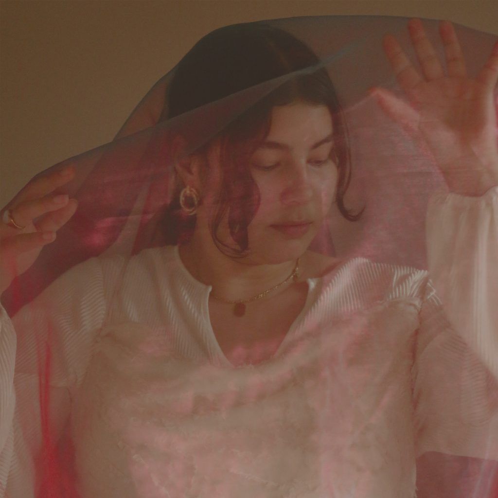 NYVE covered by a transparent cloth for the cover of her single Never Again
